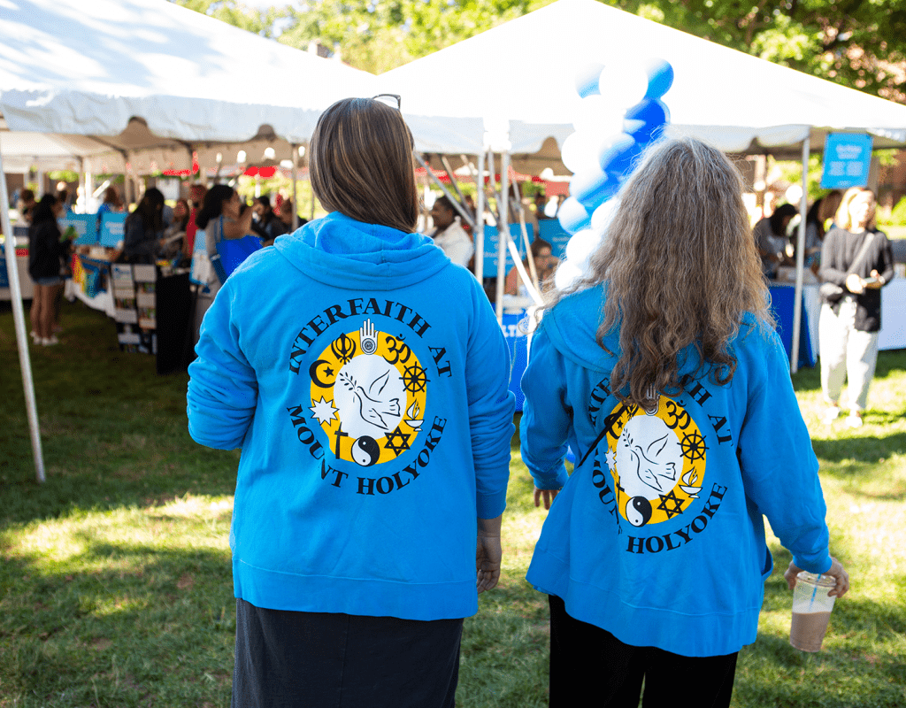 Staff members wearing sweatshirts that say &quot;Interfaith at Mount Holyoke&quot;