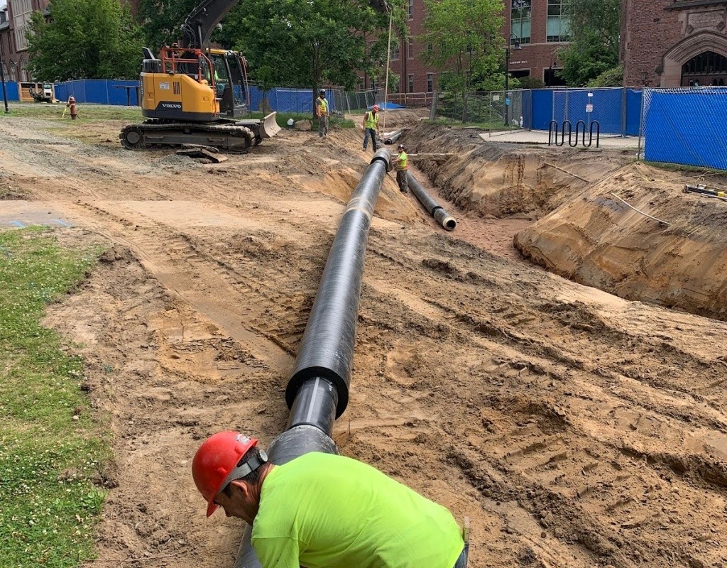 Laying down pipes during phase one of the geothermal project.