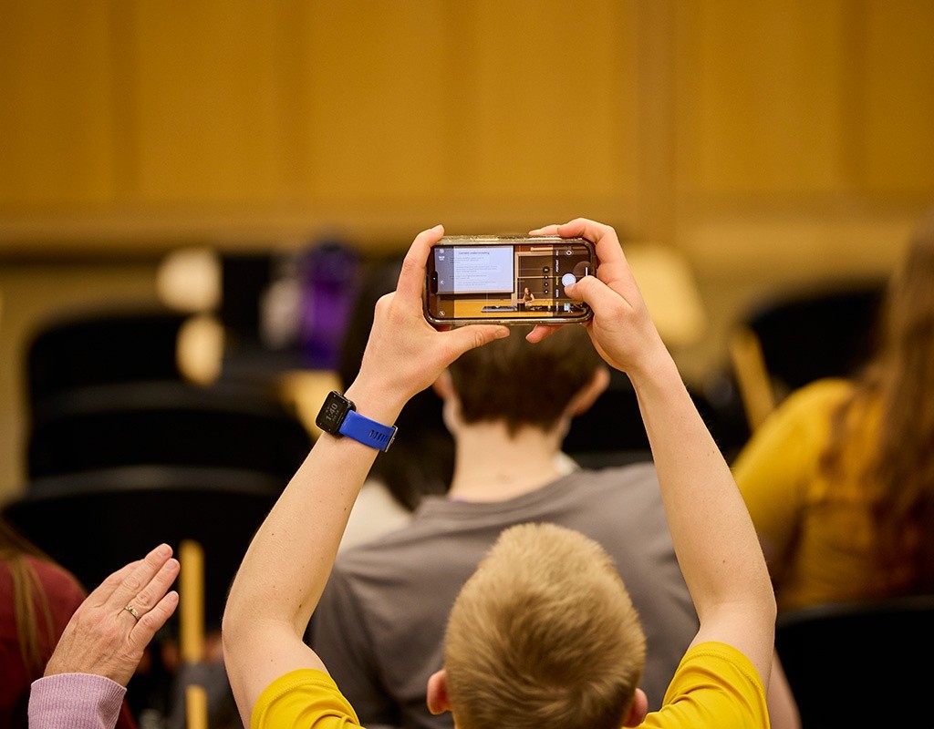 Someone holds up a camera to record the Senior Symposium at Mount Holyoke College, April 18, 2025.