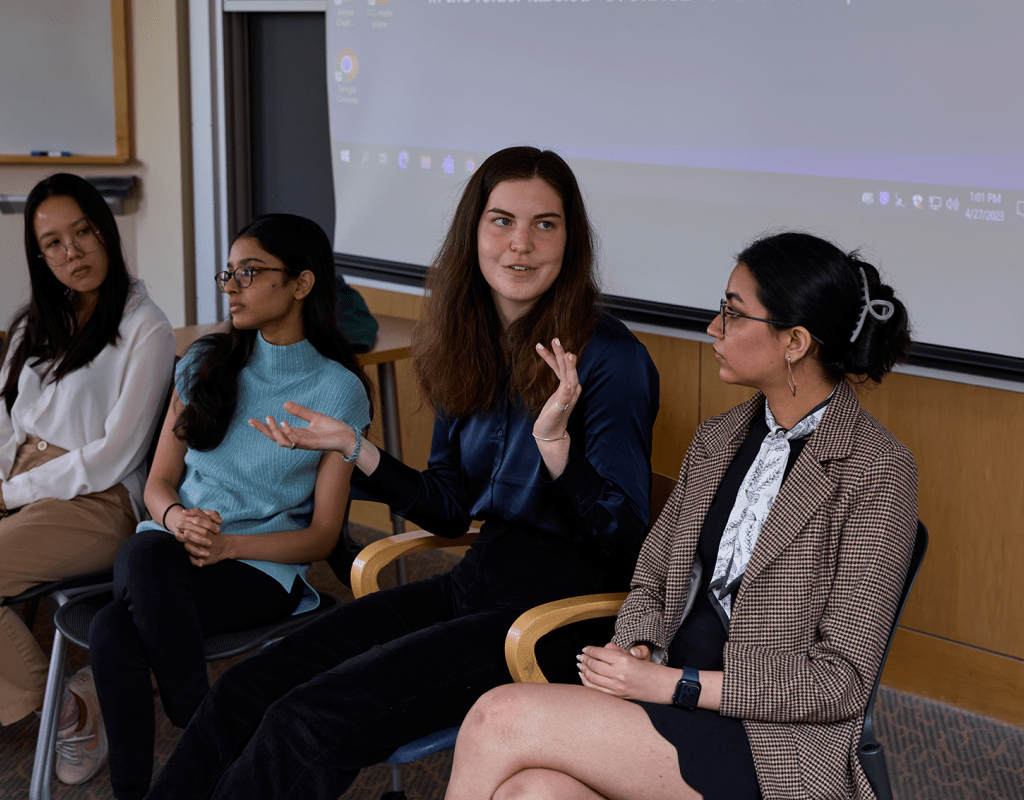 A group of students seated during their presentation at Senior Symposium 2023