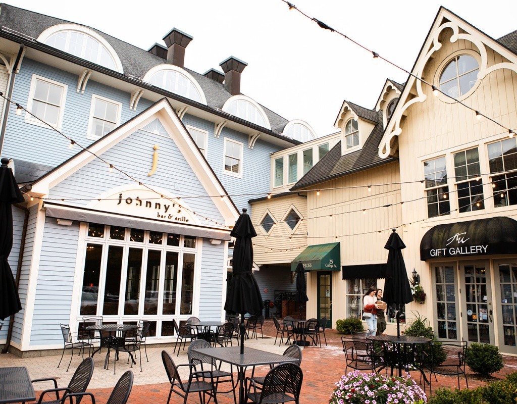 A courtyard by Johnny's Bar &amp; Grille in the Village Commons