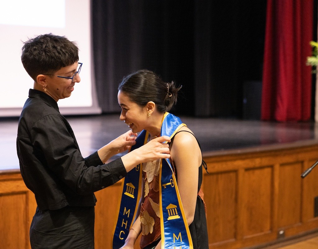 A student receives their stole during the ceremony