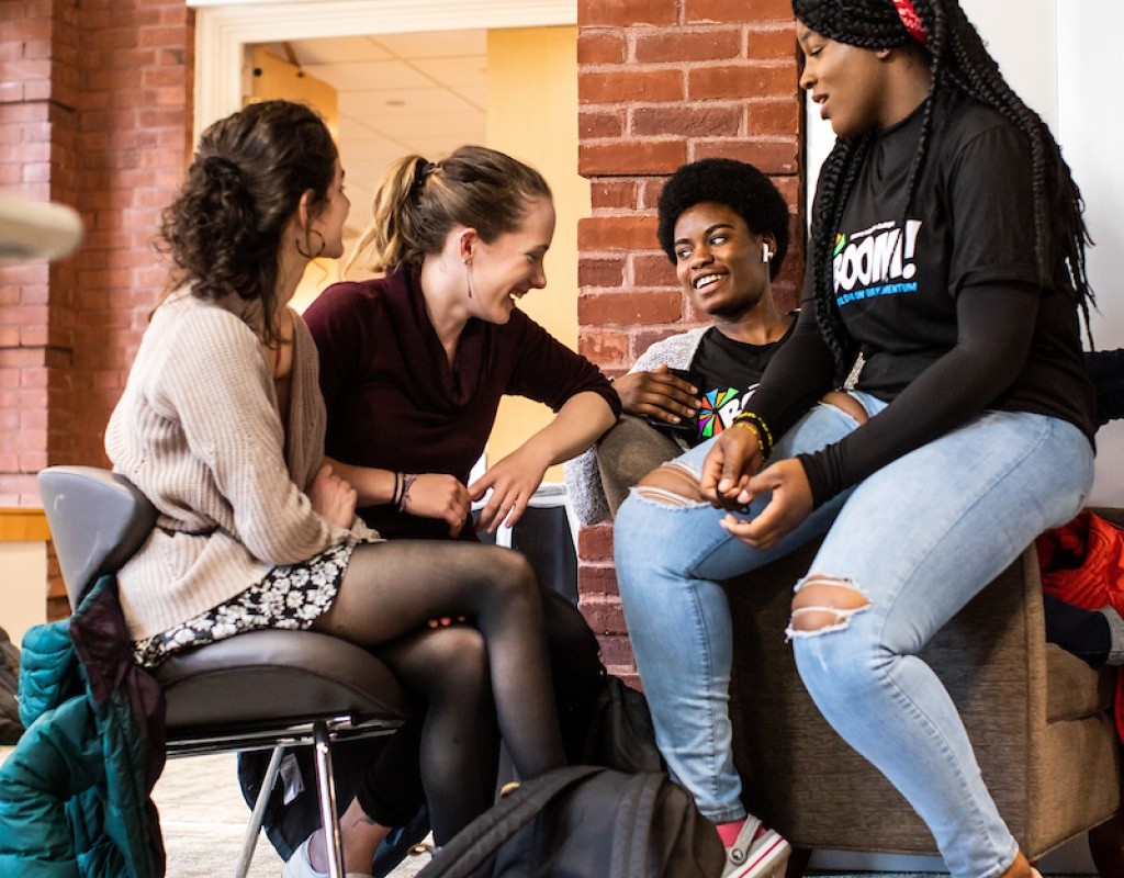 A small group of students having a discussion during the BOOM Learning Symposium