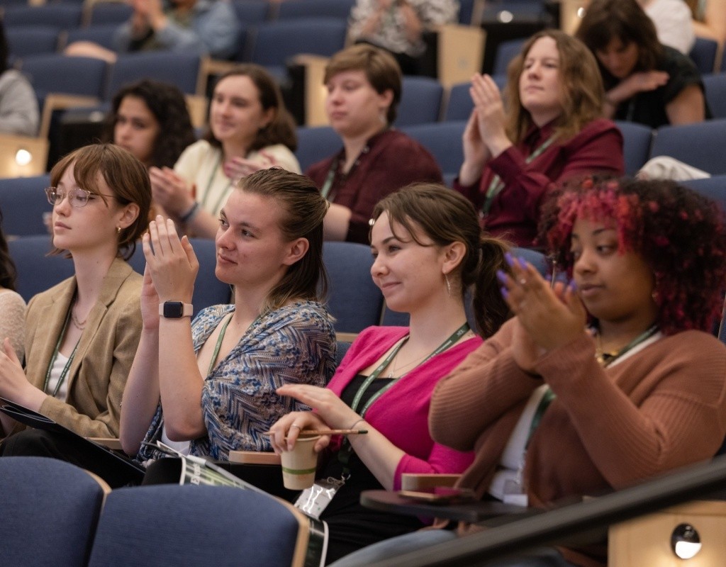 Audience clapping during a session at the Summit on Climate Justice held in April 2023
