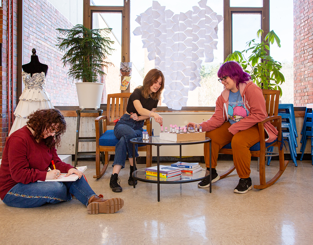 Three people enjoying the gathering space in the Art Building