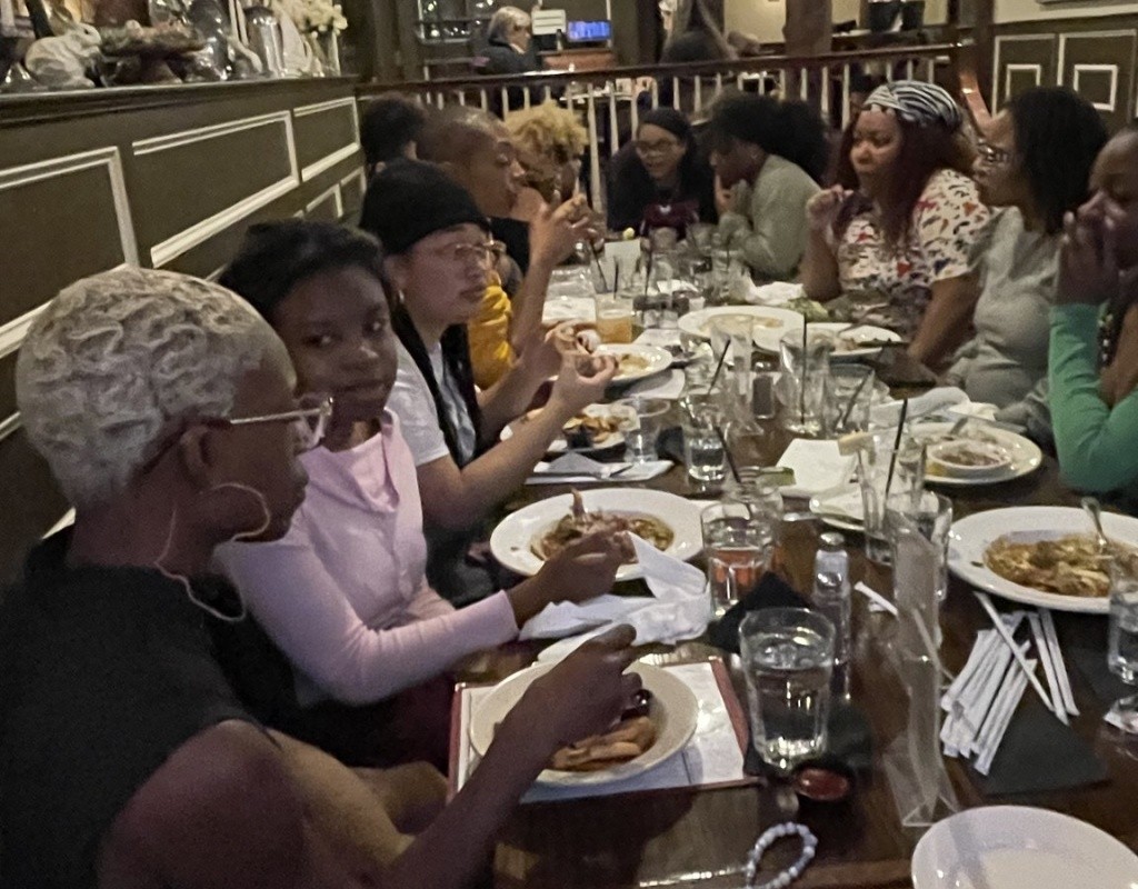 TOCLC attendees sit together having lunch.