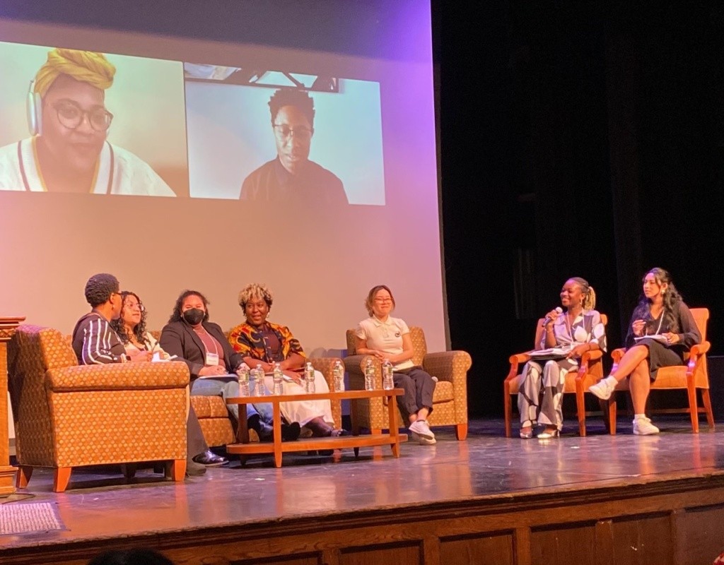 A group of panelists on stage, TOCLC.