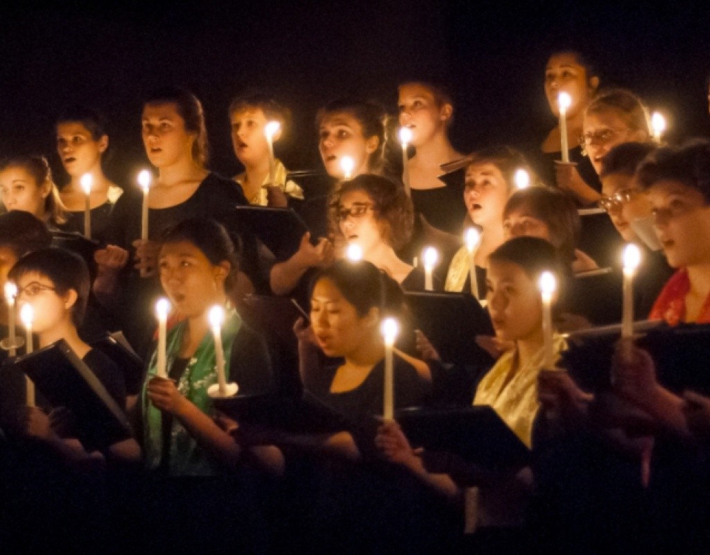 Students singing by candlelight during a Vespers concert