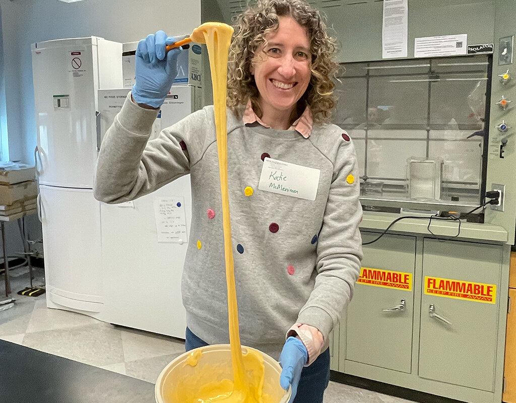 Professor Kate McMenamin shows off slime's elasticity.