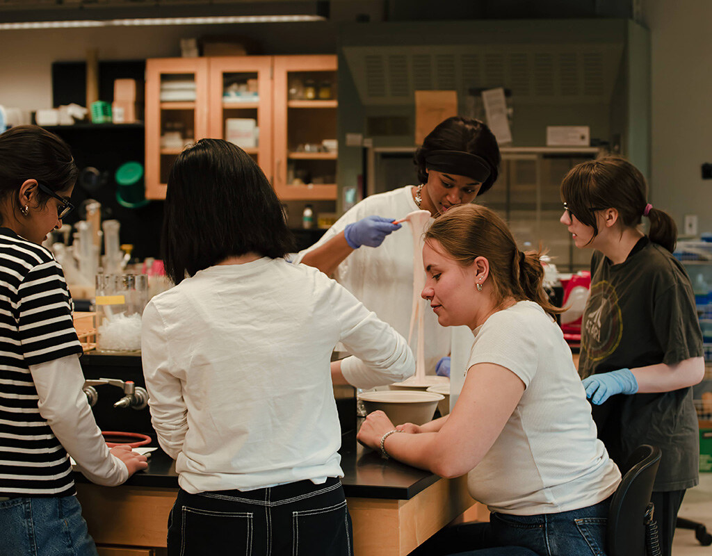 MHC students work together to measure and heat ingredients to make slime
