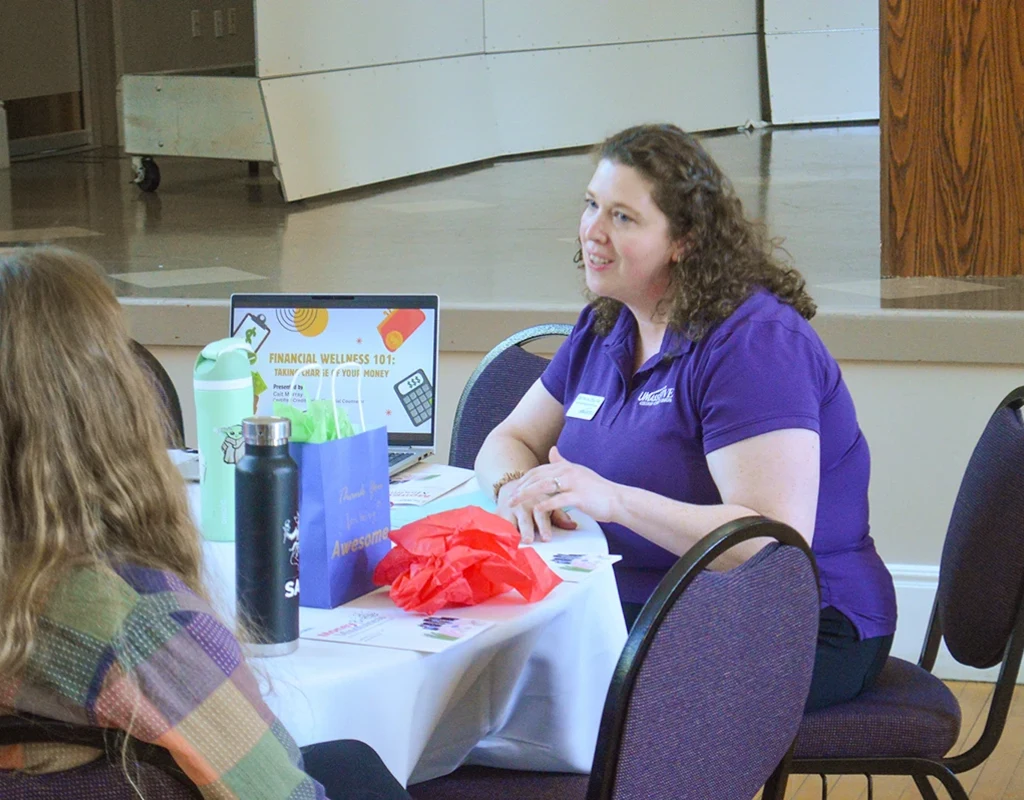 UMass Five Community Outreach Manager Cait Murray talks one-on-one with a student about the importance of taking charge of your money.