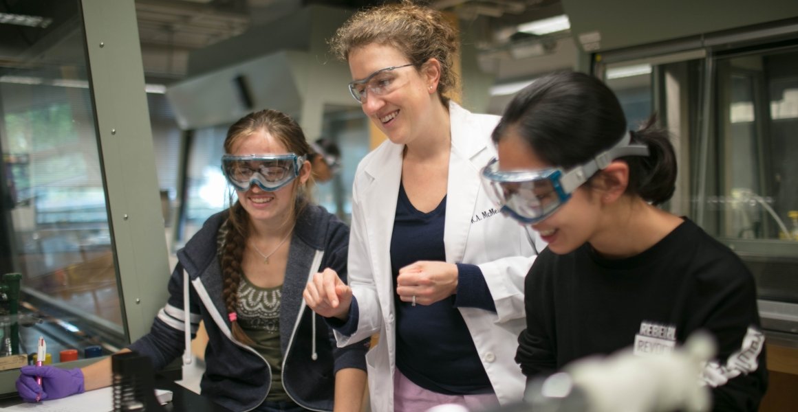 Students working in lab with faculty.