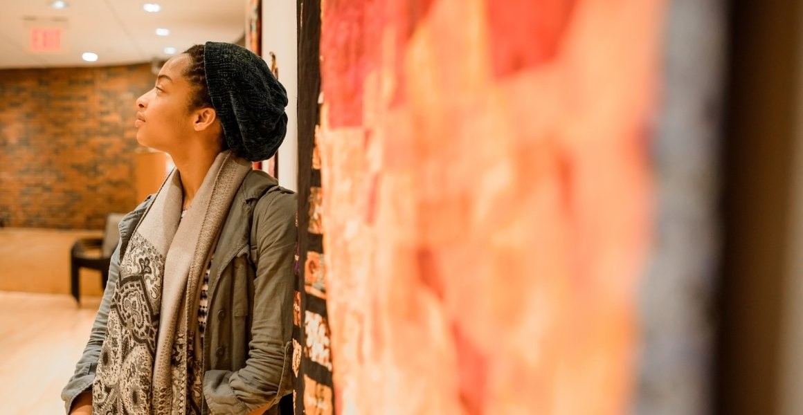 Student leaning at the Art Museum Gallery