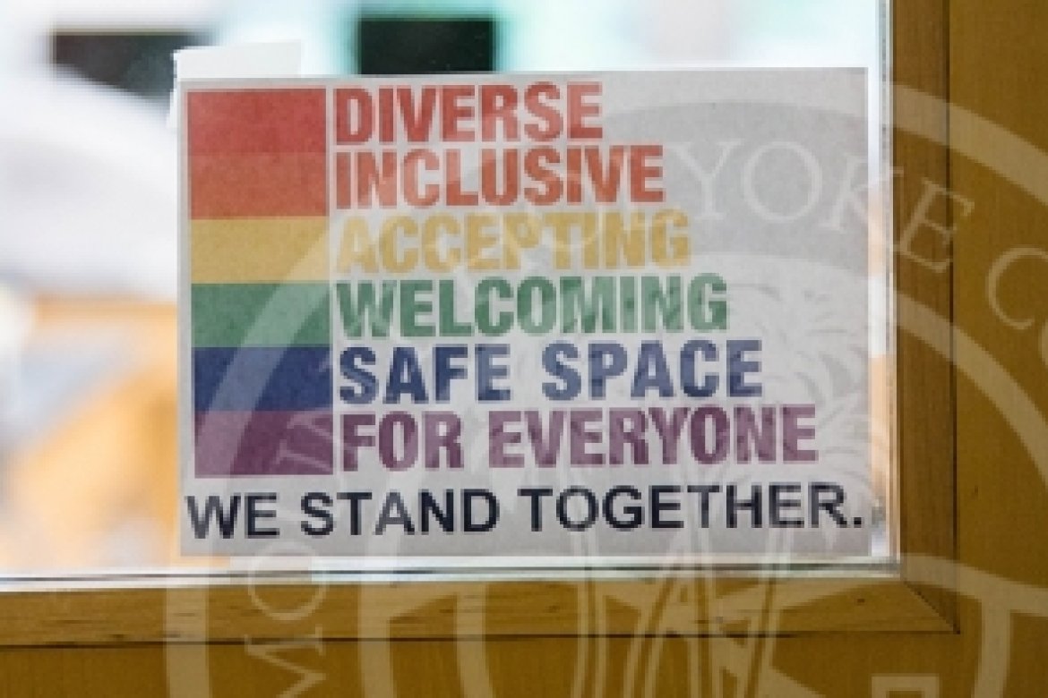 Sign on door that reads "Diverse, Inclusive, Accepting, Welcoming, Safe Space for Everyone, we stand together".