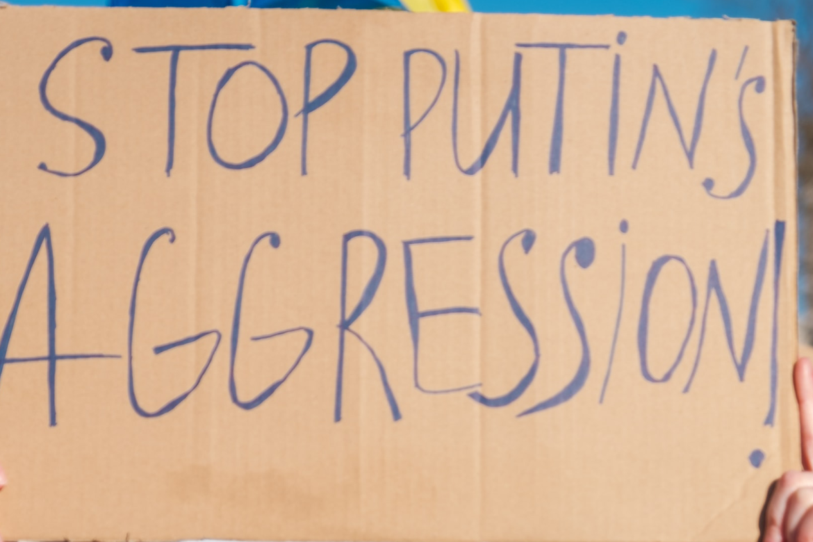 A sign that says "Stop Putin's Aggression"