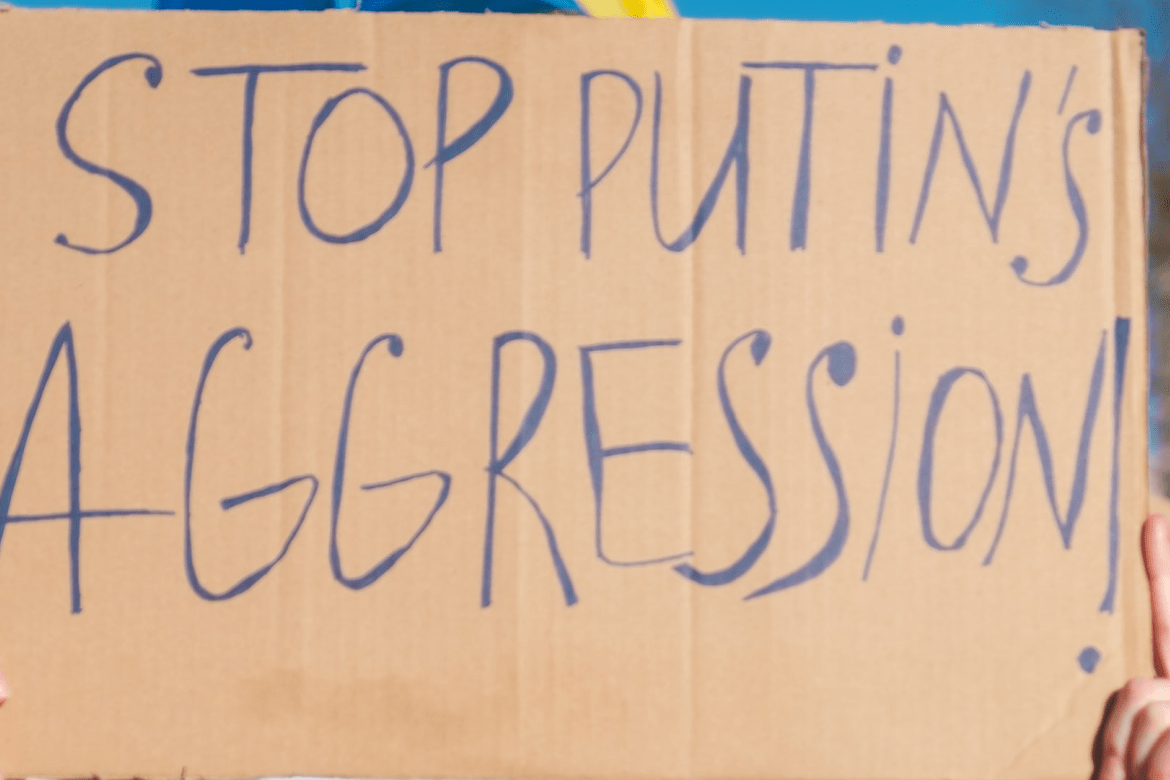 A sign that says "Stop Putin's Aggression"