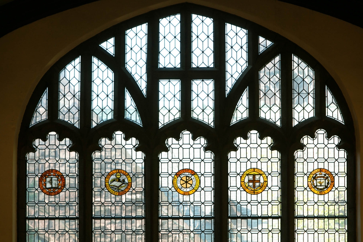 A window in the Mount Holyoke College library that displays seals of five colleges