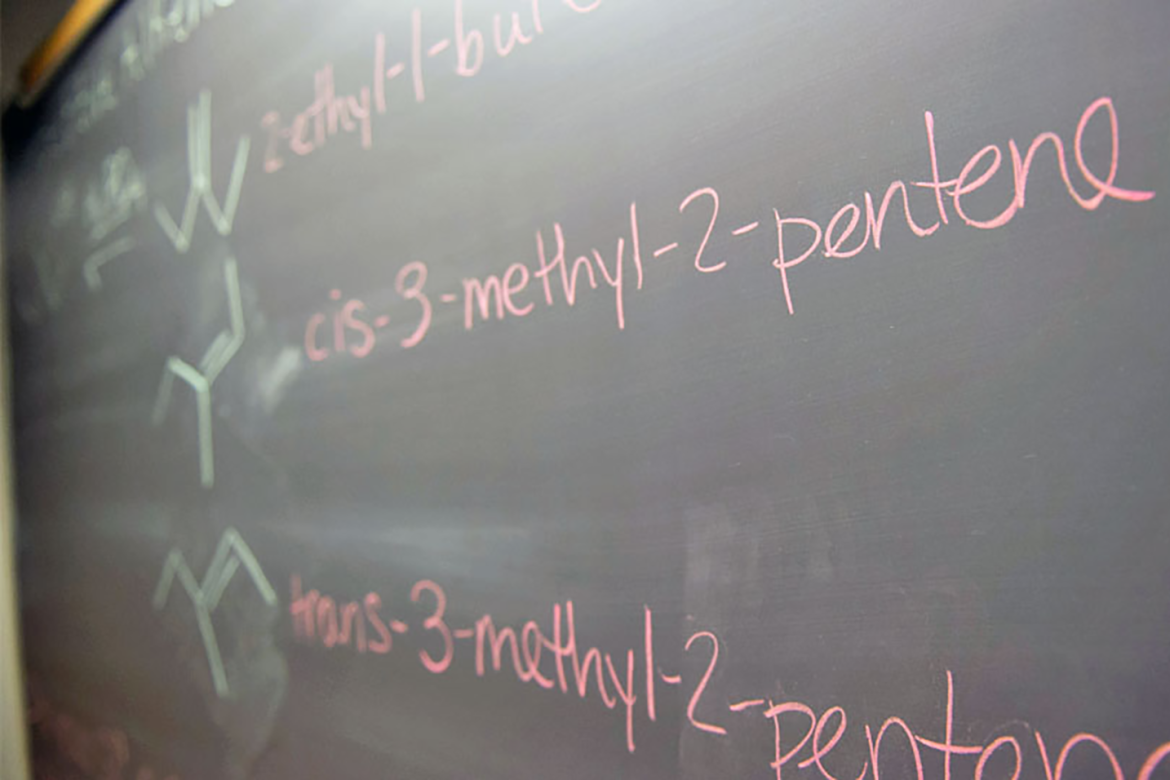 Chemistry terms written on a chalkboard