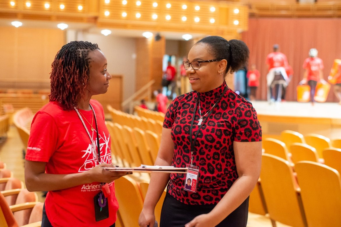 Arsht Center intern Emma Moise ’25 (right) discusses a schedule change with one of the camp directors for AileyCamp Miami. Photo by Justin Namon.