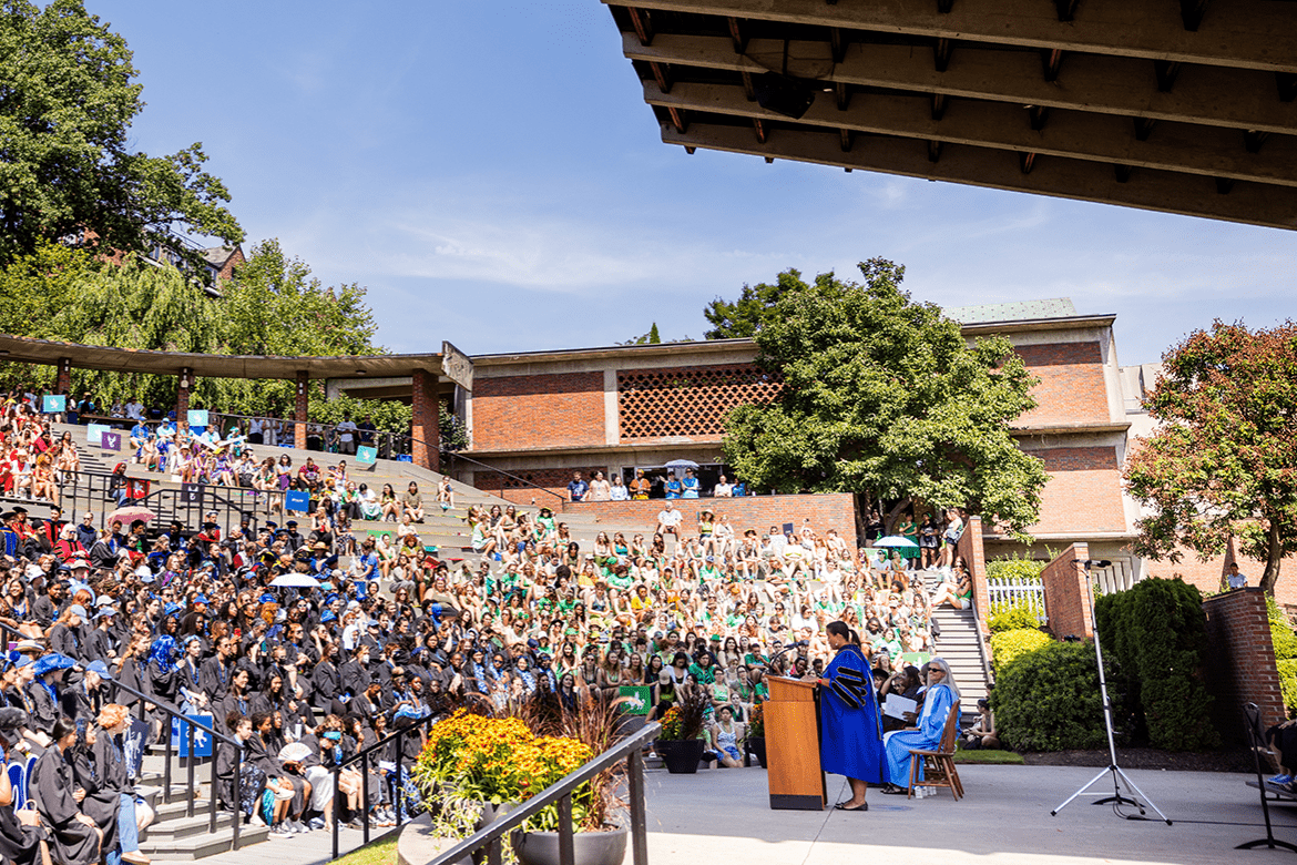 Students in the amphitheater during Convocation 2023 with President Danielle R. Holley at the podium