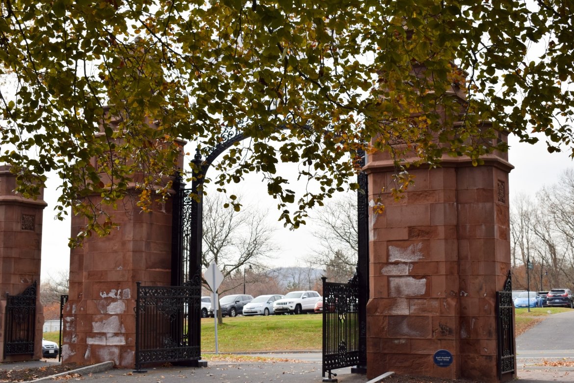 The Gates of Mount Holyoke framed by leaves starting to turn colors.