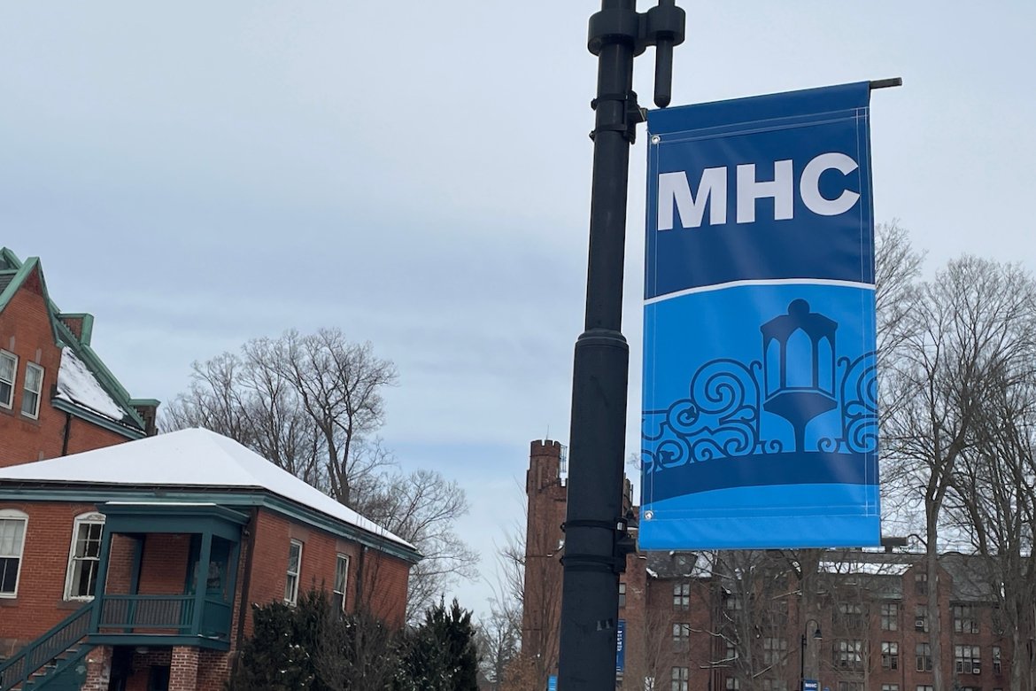 MHC campus banners with the gate on a cloudy winter's day