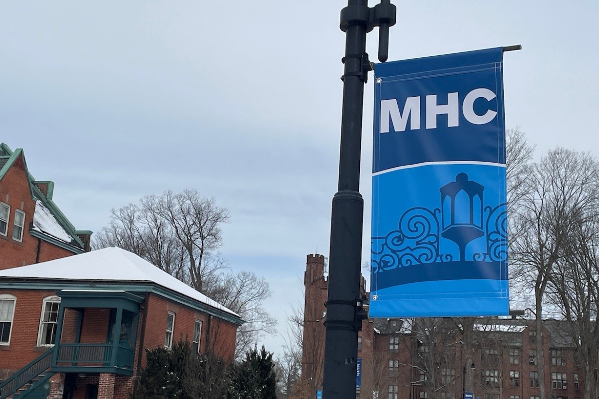 MHC campus banners with the gate on a cloudy winter's day