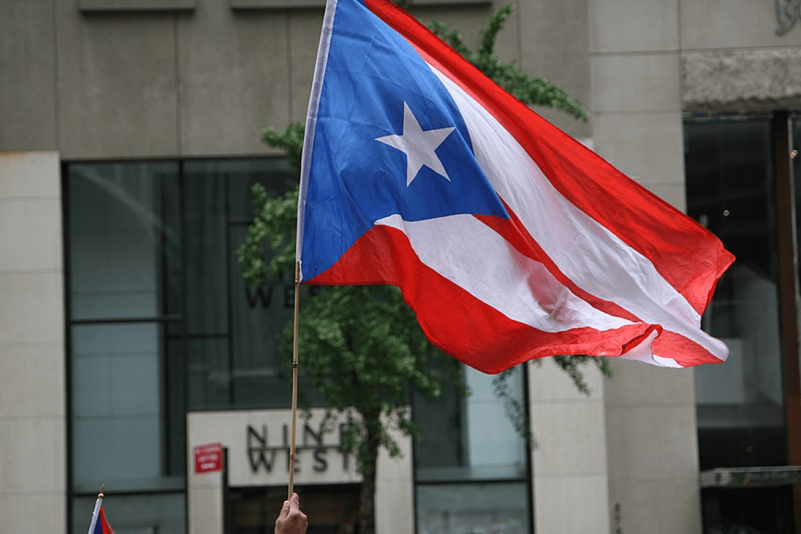 The flag of Puerto Rico being waved in a crowd 