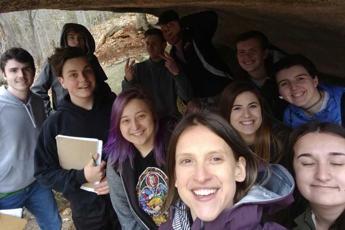 Katharine Hinkle ’02 and her geology students underneath a glacial erratic in Franconia Notch, NH.