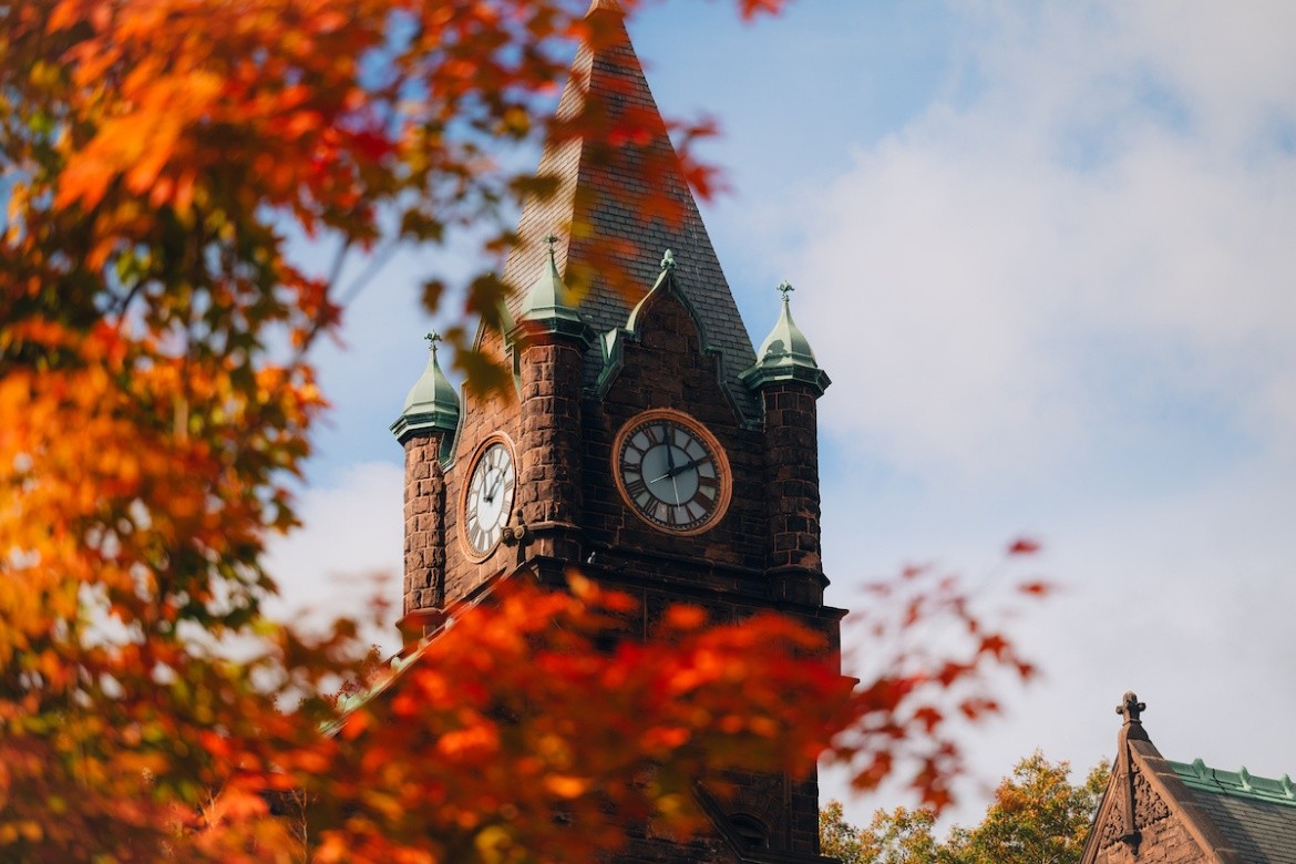 Mount Holyoke College clock tower highlighted by red leaves in the fall of 2024. Photo by Max Wilhelm.