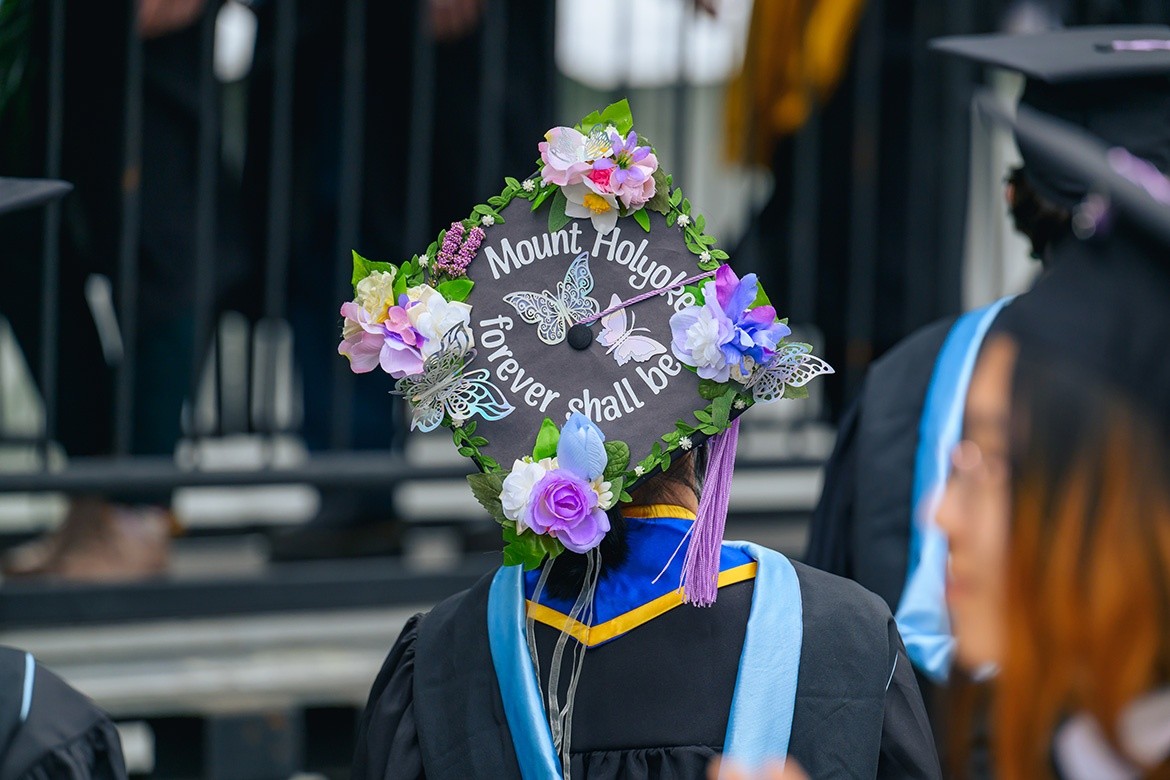 Mount Holyoke student decorated their mortarboard with the words Mount Holyoke Forever Shall Be and flowers