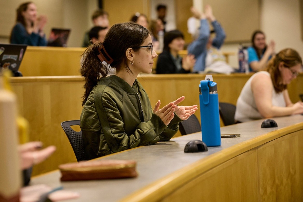 Student clapping in a lecture hall.