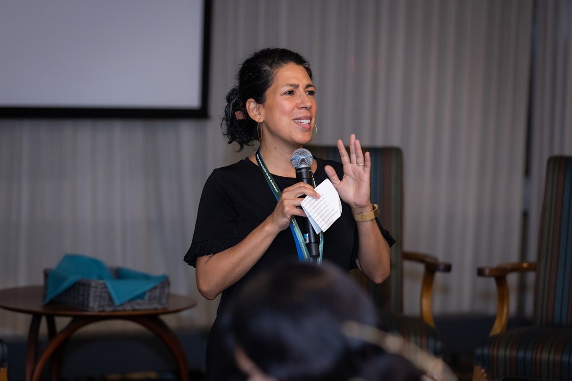 Olivia Aguilar speaking in front of an audience, photo by Jo Chattman.
