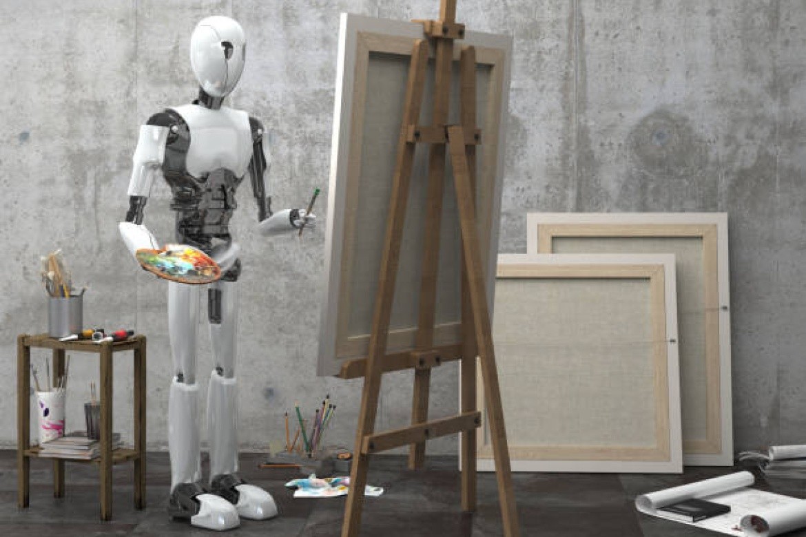 A robot stands near an easel with a paint brush in one hand and a pallette in the other
