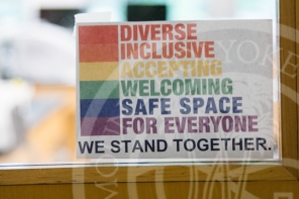 Sign on door that reads "Diverse, Inclusive, Accepting, Welcoming, Safe Space for Everyone, we stand together".