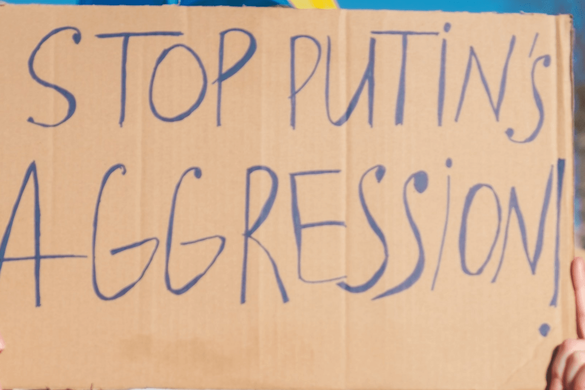 A sign that says "Stop Putin's Aggression"