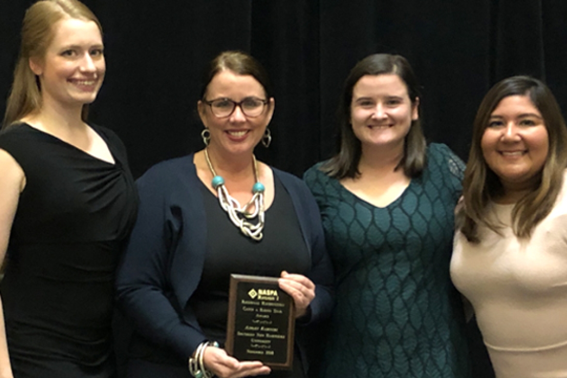 The Be Well initiative was named Program of the Year by NASPA. Pictured at the awards ceremony (from left): Christine Albain, Marcella Runell Hall, Caroline Horne and Ivonne Ramirez, all from the Division of Student Life. 