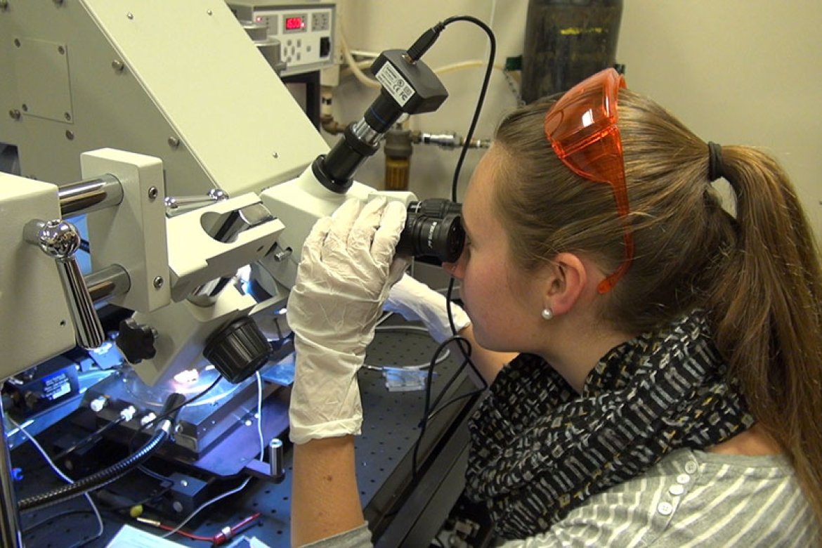 Alumna Margaret Stevens ’14 works in her lab at Tufts University.