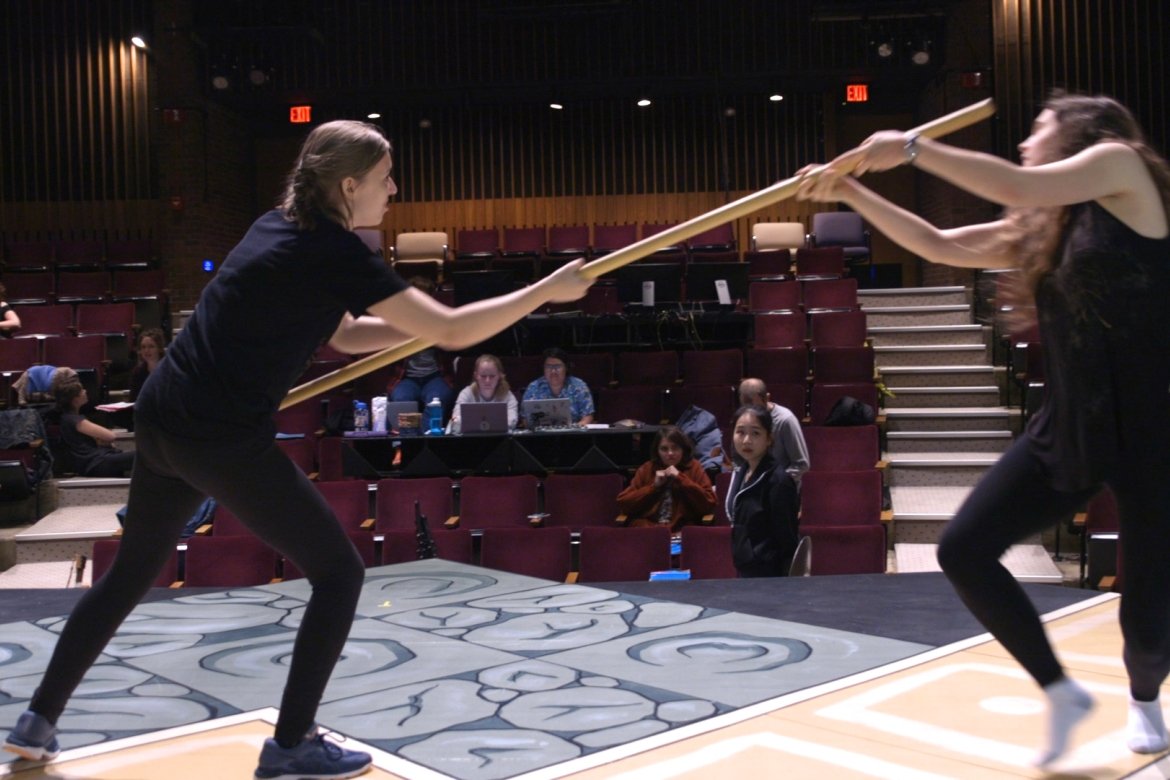 D&D comes to life in the play “She Kills Monsters”: Kaliope (Adelia Brown ’22, left) uses the quarterstaff to knock out Farrah the Faerie (Ezri Braid-Grizzell ’23) so she can move forward in the adventure.