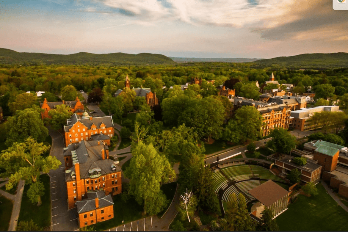 An aerial view of campus with Gettell amphitheater in the foreground and the Mary Lyon Hall clocktower in the background