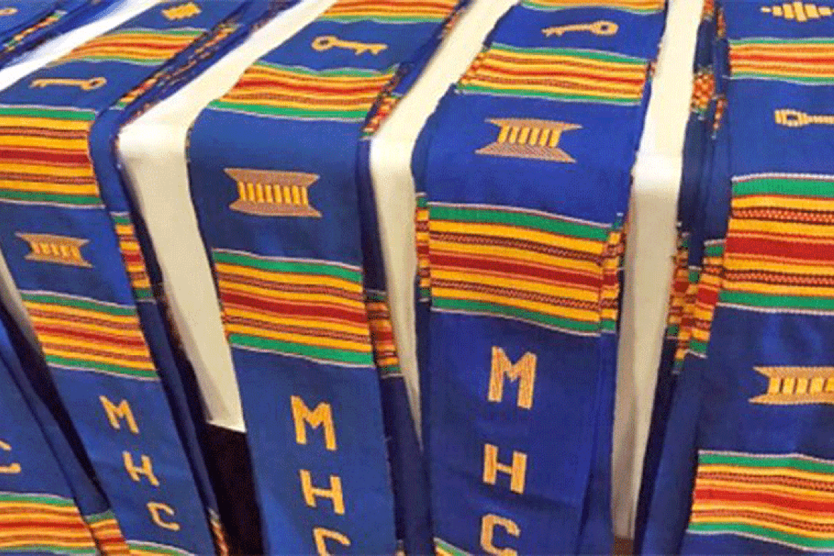 Stoles made of boldly colored kente cloth that is embroidered with “MHC” and special symbols.