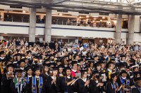 Graduates clapping during Commencement 2023