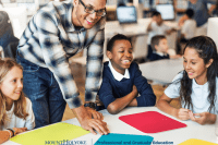 Students in a circle looking at colored pieces of paper.