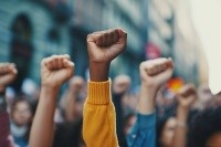 Fisted hands are raised in the air.