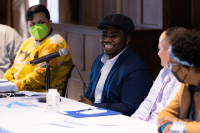 Malakai Chuckas ’20 smiling during a panel discussion at BOOM 2023