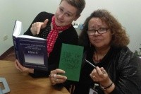 Megan Brookman with her supervisor holding a “Be the Change” sign. Image courtesy of Megan Brookman ‘14.