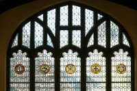 A window in the Mount Holyoke College library that displays seals of five colleges