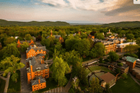An aerial view of campus with Gettell amphitheater in the foreground and the Mary Lyon Hall clocktower in the background