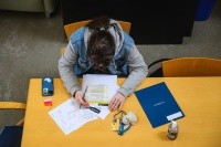 Overhead view of a student looking at paperwork at the Sophomore Institute at Mount Holyoke College.