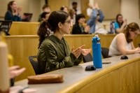 Student clapping in a lecture hall.